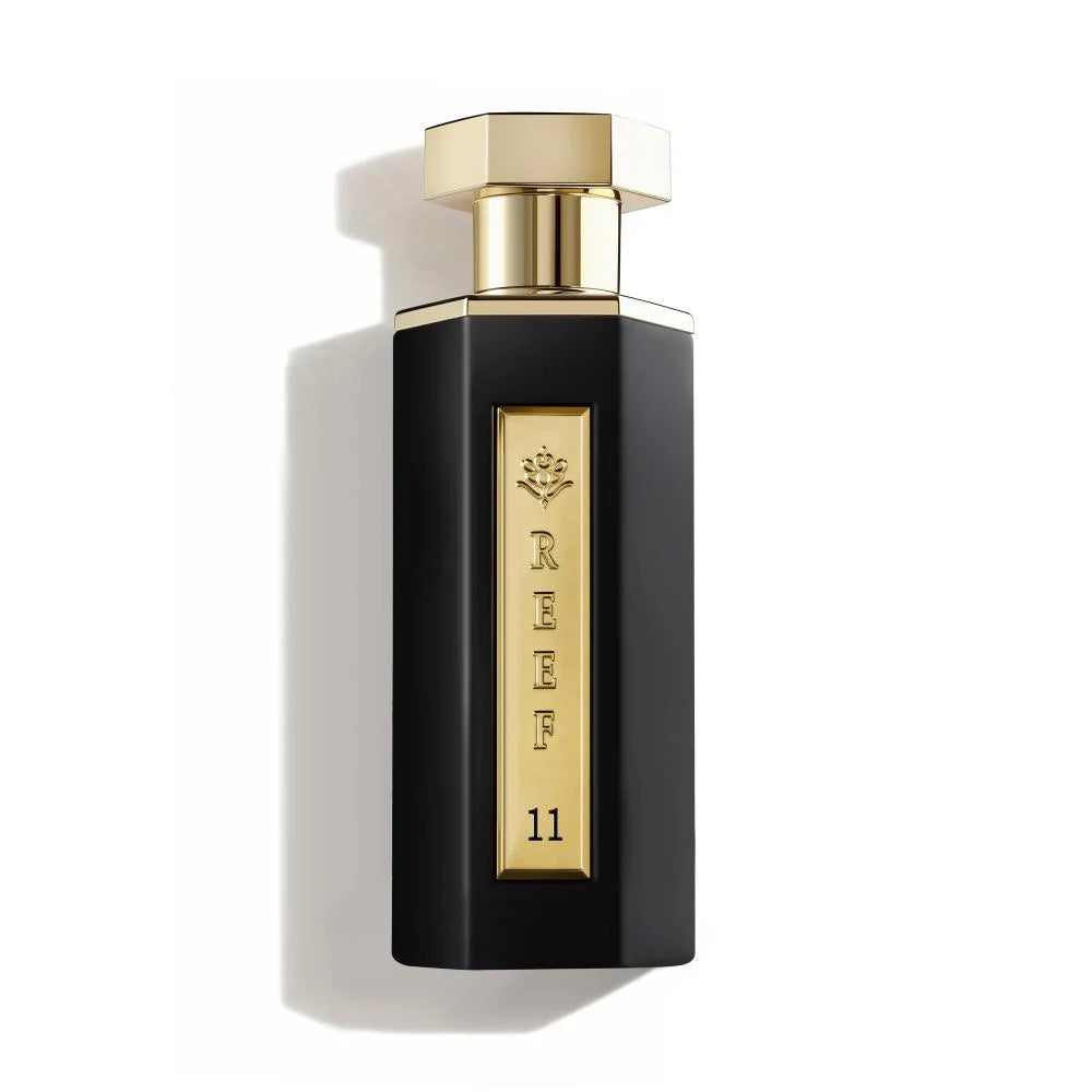 Perfume bottle with gold cap and label on a white background