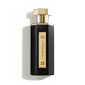 Perfume bottle with gold cap and 'REEF 33' branding on a white background